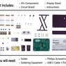 Many small parts layed out flat. Text indicating kit included 45+ components, a circuit board, display stand, and instructions.